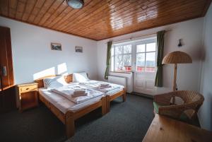 Postel nebo postele na pokoji v ubytování Hotel Večernice
