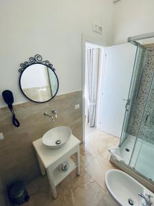 a bathroom with a sink and a mirror at Domus Valadier B&B Guesthouse in Fiumicino