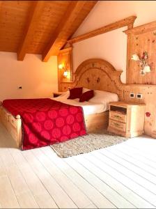 a bedroom with a large bed with a red blanket at Bella Vista in Canale San Bovo
