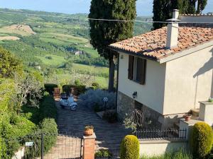 a house with a view of a valley at La Fontanella Country House in Celle sul Rigo