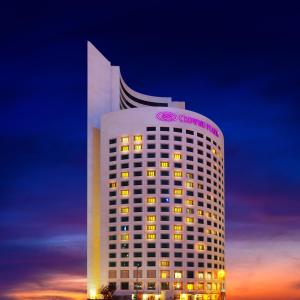 a tall white building with a company sign on it at Crowne Plaza Istanbul Oryapark by IHG in Istanbul