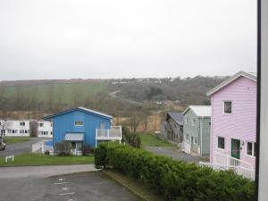 a row of colorful houses in a town at Freshwater Bay Holiday Cottages in Pembroke