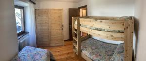 a bedroom with two bunk beds in a room at Casa Ornella in Courmayeur