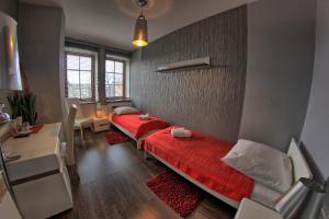 a bedroom with a large red bed in a room at Polonia in Ostrów Wielkopolski