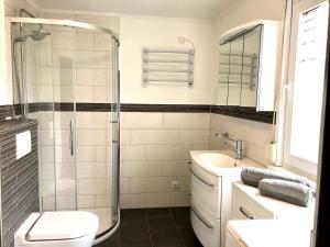 a bathroom with a shower and a toilet and a sink at Haus Seeblick Ferienhaus Priwall in Priwall