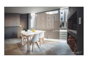 a dining room with a white table and chairs at Felzarette Self Catering Apartment 7 in Windhoek