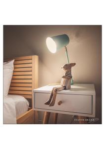 a toy dog sitting on a nightstand with a lamp at Felzarette Self Catering Apartment 7 in Windhoek