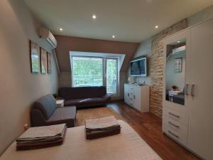 een woonkamer met een bank en een stoel bij Apartment For You in Varna