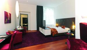 ein Hotelzimmer mit einem Bett und einem TV in der Unterkunft Hotel Gräfrather Hof in Solingen