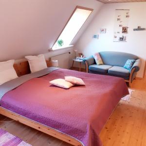a bedroom with a large bed and a couch at Agnes Bed and Breakfast in Bække