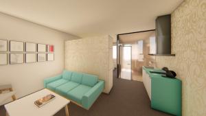 a living room with a blue chair and a table at Centrum Apartmán LEYLA 3 in Bardejov