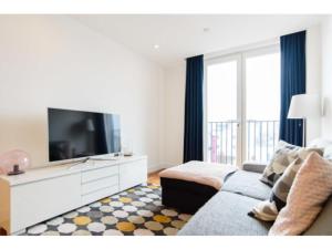 a living room with a couch and a flat screen tv at The Most Central Apartment in Cardiff in Cardiff