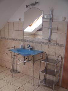 a bathroom with a blue sink and a mirror at Akacia Apartment - FREE PARKING INSIDE OUTSIDE 2 bedrooms garden next to centre in Budapest