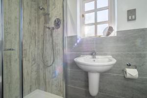 a bathroom with a sink and a shower at Cob Cottage in St. Agnes +23 photos