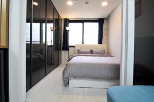 a bedroom with a bed and a glass wall at Stay 290 in Jeju