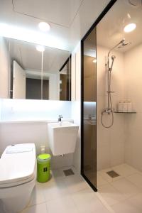 a bathroom with a sink and a toilet and a shower at Stay 290 in Jeju