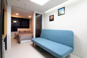 a room with a blue bench and a bed at Stay 290 in Jeju