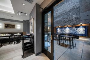 a restaurant with a bar with a stone wall at Pestana Park Avenue in New York