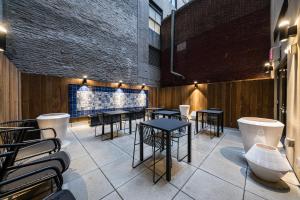 a restaurant with tables and chairs and a brick wall at Pestana Park Avenue in New York