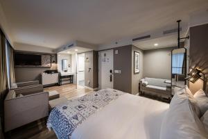 a bedroom with a large bed and a living room at Pestana Park Avenue in New York