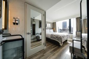 a hotel room with a bed and a mirror at Pestana Park Avenue in New York