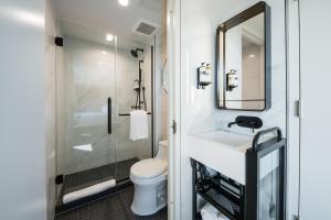 a bathroom with a toilet and a sink and a mirror at Pestana Park Avenue in New York