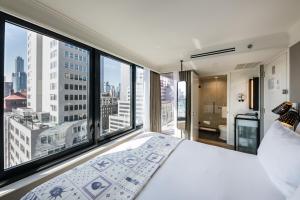 a bedroom with a large bed and a large window at Pestana Park Avenue in New York