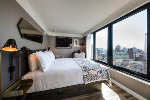 a bedroom with a large bed and large windows at Pestana Park Avenue in New York