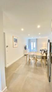 a kitchen and dining room with a table and chairs at République Appartements in Menton