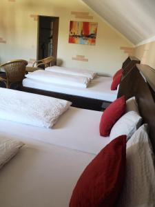 a group of four beds in a room at Hotel Köln-Bonn in Bornheim