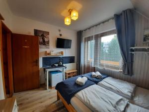 Postel nebo postele na pokoji v ubytování Pokoje Gościnne KAMI