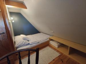 ヴェスターヘーヴァーにあるFerienkate Kap Eiderstedtのベッドとテーブル付きの小さな部屋
