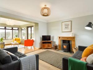 a living room with a couch and a fireplace at Borgan Cottage in Newton Stewart
