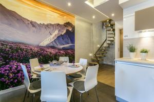 a dining room with a table and purple flowers at VIP Apartamenty Stara Polana in Zakopane