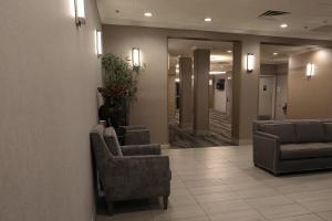 a lobby with couches and chairs in a building at Holiday Inn O'Hare Area, an IHG Hotel in Rosemont