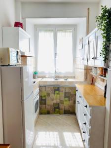 a kitchen with a white refrigerator and a window at Vatican Town House in Rome +38 photos