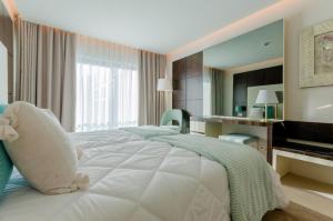 a bedroom with a bed with a teddy bear on it at Hotel Alvorada in Estoril