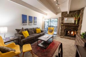 a living room with a couch and a fireplace at Villa Cortina by Vail Realty in Vail