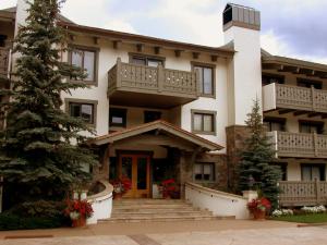 a large building with a tree in front of it at Villa Cortina by Vail Realty in Vail