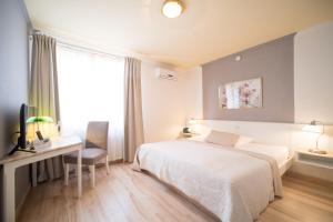 Postel nebo postele na pokoji v ubytování Hotel Toskana