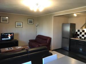a living room with a couch and a refrigerator at Appartement à Metz Technopole 24 in Metz