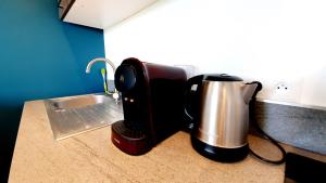 a coffee maker on a counter next to a sink at Le nid douillet d'Angèlique et David avec Parking in Rambouillet