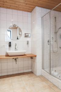 a bathroom with a sink and a shower at Gasthof Fallmühle in Pfronten