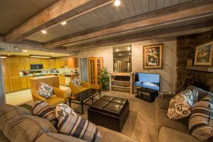 a living room with two couches and a television at Villa Cortina by Vail Realty in Vail