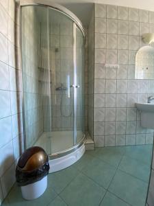a bathroom with a shower and a trash can at Willa Ewa in Jantar +82 photos