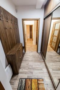 a hallway with wooden doors and tile floors at Górski szafir in Jaworki