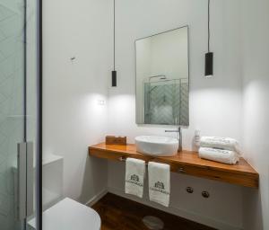 a bathroom with a sink and a mirror at CASA DA GRAÇA in Ponta Delgada +48 photos