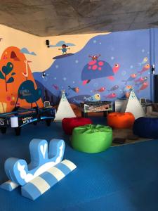 a room with a wall with a painting on it at Cinnamon Bentota Beach - Signature Selection in Bentota