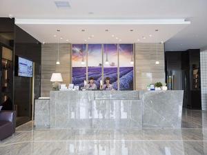 a lobby with a reception desk in a building at Lavande Hotel Zhengzhou Economic Zone International Logistics Park in Zhengzhou