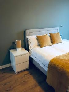 a bedroom with a bed with two pillows and a night stand at Quayside Central in Liverpool